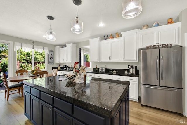 644 Canterbury Cir, Vacaville, CA 95687 - kitchen featuring freestanding refrigerator, healthy amount of natural light, tile counters, white cabinets, and recessed lighting