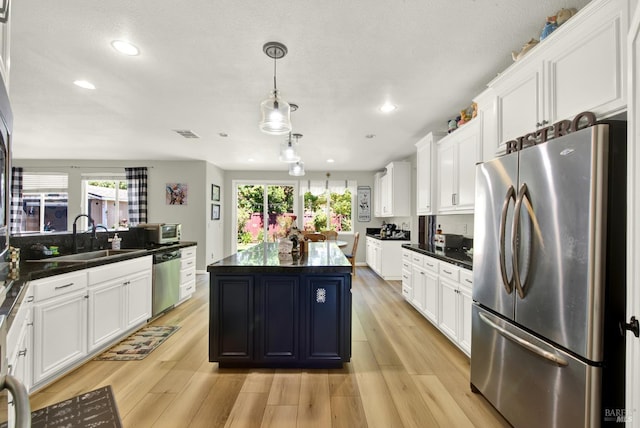 644 Canterbury Cir, Vacaville, CA 95687 - kitchen featuring stainless steel appliances, dark countertops, white cabinetry, recessed lighting, and healthy amount of natural light