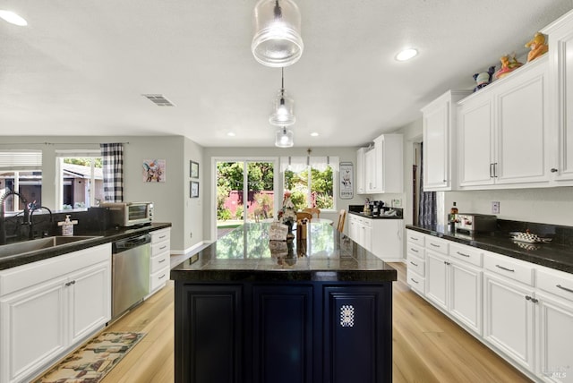 644 Canterbury Cir, Vacaville, CA 95687 - kitchen featuring stainless steel dishwasher, light wood-style flooring, white cabinetry, dark countertops, and recessed lighting
