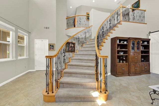 644 Canterbury Cir, Vacaville, CA 95687 - staircase featuring a high ceiling, tile patterned flooring, recessed lighting, and a barn door
