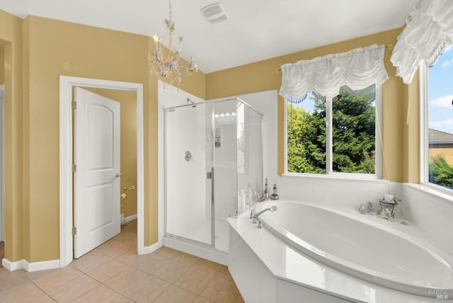 644 Canterbury Cir, Vacaville, CA 95687 - full bathroom with a shower stall, a garden tub, tile patterned flooring, and a chandelier