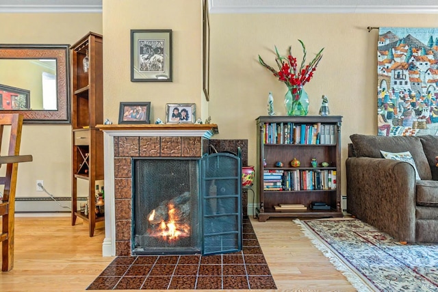 7771 Healdsburg Ave Unit 22, Sebastopol, CA 95472 - living room with a tile fireplace, wood finished floors, baseboard heating, and ornamental molding