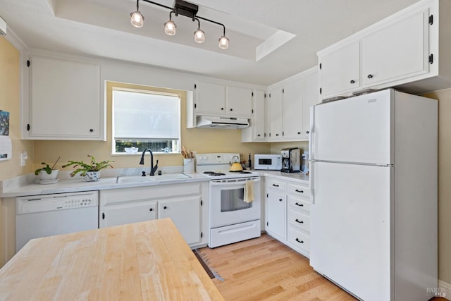 7771 Healdsburg Ave Unit 22, Sebastopol, CA 95472 - kitchen featuring white appliances, under cabinet range hood, light countertops, light wood-type flooring, and white cabinetry