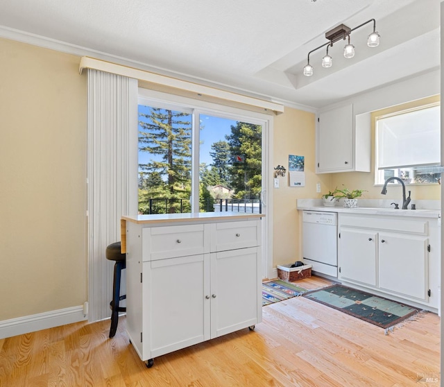 7771 Healdsburg Ave Unit 22, Sebastopol, CA 95472 - kitchen with dishwasher, light wood-style floors, white cabinets, light countertops, and plenty of natural light