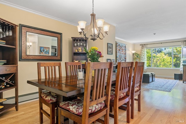 7771 Healdsburg Ave Unit 22, Sebastopol, CA 95472 - dining space featuring light wood-style flooring, a chandelier, crown molding, and baseboard heating