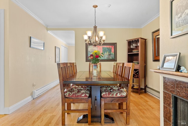 7771 Healdsburg Ave Unit 22, Sebastopol, CA 95472 - dining room with baseboard heating, light wood finished floors, a chandelier, and ornamental molding