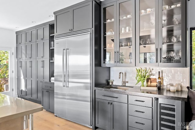 1325 Crestmont Dr, Angwin, CA 94508 - indoor wet bar featuring built in fridge, beverage cooler, light wood finished floors, and decorative backsplash