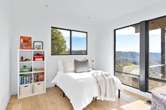 1325 Crestmont Dr, Angwin, CA 94508 - bedroom with multiple windows, wood finished floors, and a mountain view