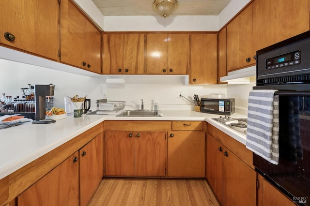 15 Montecito Dr, Corte Madera, CA 94925 - kitchen with black appliances, light wood finished floors, light countertops, brown cabinets, and under cabinet range hood