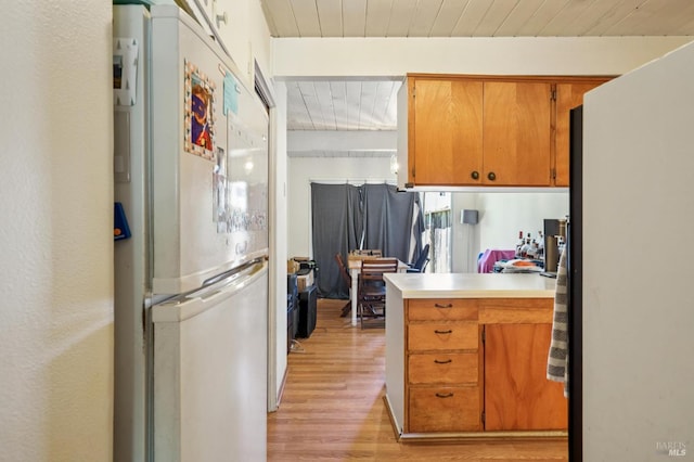 15 Montecito Dr, Corte Madera, CA 94925 - kitchen with freestanding refrigerator, light wood finished floors, wood ceiling, brown cabinetry, and light countertops