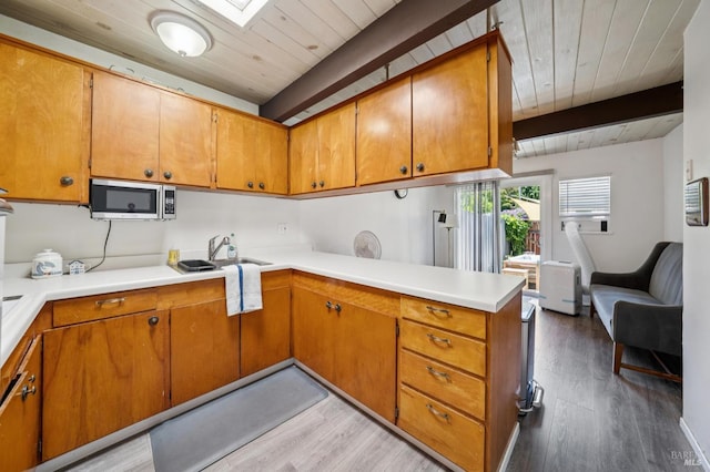 15 Montecito Dr, Corte Madera, CA 94925 - kitchen featuring stainless steel microwave, a wood ceiling with exposed beams, light wood finished floors, a peninsula, and brown cabinets