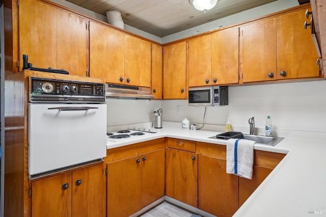 15 Montecito Dr, Corte Madera, CA 94925 - kitchen with white appliances, under cabinet range hood, light countertops, brown cabinets, and wood ceiling