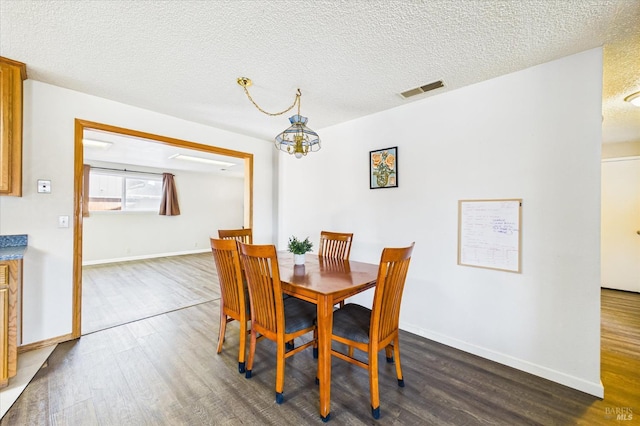 2393 Ohio St, Eureka, CA 95501 - dining area with dark wood-style flooring, a chandelier, and a textured ceiling
