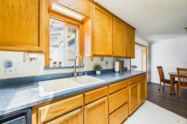 2393 Ohio St, Eureka, CA 95501 - kitchen with brown cabinetry, dark countertops, and a textured ceiling