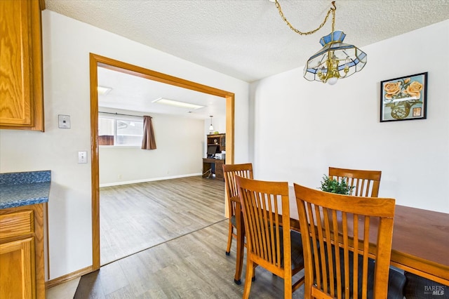 2393 Ohio St, Eureka, CA 95501 - dining area with wood finished floors, a chandelier, and a textured ceiling