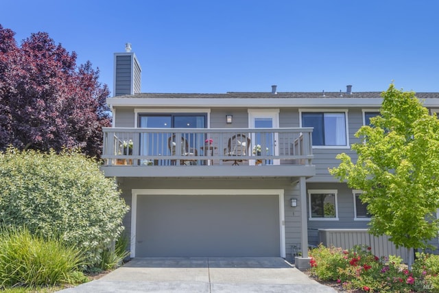 1 Drakes View Cir, Greenbrae, CA 94904 - view of property with a chimney, a balcony, driveway, and an attached garage