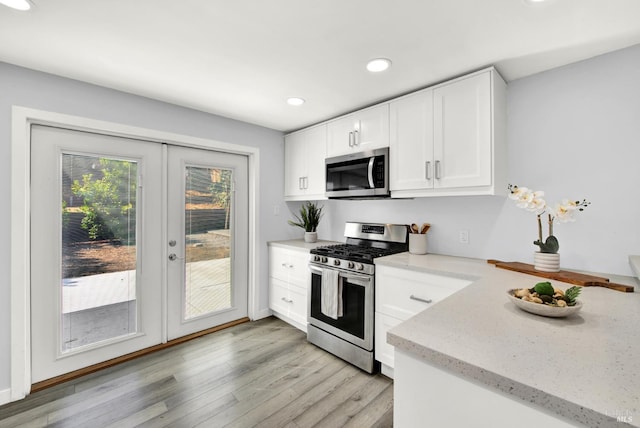 2876 Hilltop Rd, Concord, CA 94520 - kitchen with stainless steel appliances, french doors, light wood-style flooring, light stone countertops, and white cabinets