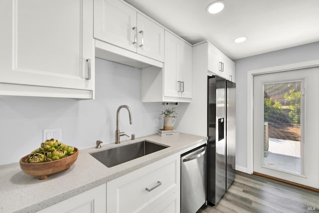 2876 Hilltop Rd, Concord, CA 94520 - kitchen featuring stainless steel appliances, white cabinets, light stone countertops, light wood finished floors, and recessed lighting