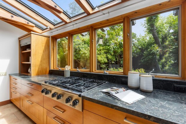 390 Panoramic Hwy, Mill Valley, CA 94941 - kitchen featuring a skylight, stainless steel gas cooktop, plenty of natural light, and dark stone counters