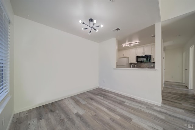 1801 Marshall Rd Unit 808, Vacaville, CA 95687 - unfurnished living room with wood finished floors and a chandelier