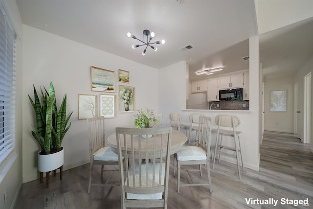 1801 Marshall Rd Unit 808, Vacaville, CA 95687 - dining room with light wood finished floors and a chandelier