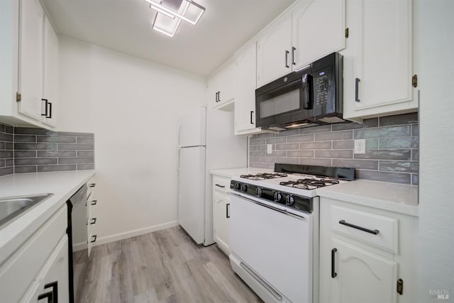 1801 Marshall Rd Unit 808, Vacaville, CA 95687 - kitchen featuring white appliances, white cabinets, light wood-type flooring, light countertops, and tasteful backsplash