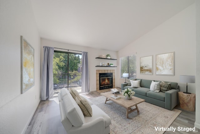 1801 Marshall Rd Unit 808, Vacaville, CA 95687 - living area featuring light wood-type flooring, a tile fireplace, and high vaulted ceiling