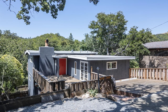23 Hillside Dr, Fairfax, CA 94930 - view of front of property with french doors, a wooden deck, and a chimney