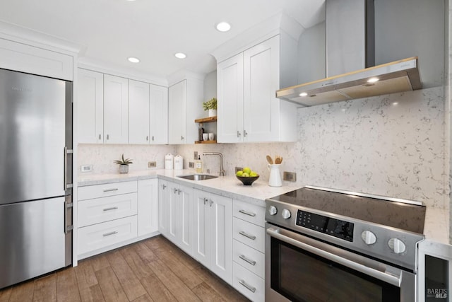 14 Corte Real Ct, Greenbrae, CA 94904 - kitchen with stainless steel appliances, wall chimney range hood, open shelves, white cabinetry, and wood finished floors