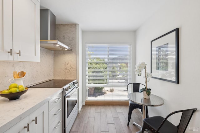 14 Corte Real Ct, Greenbrae, CA 94904 - kitchen with electric range, wall chimney range hood, light wood finished floors, white cabinets, and tasteful backsplash