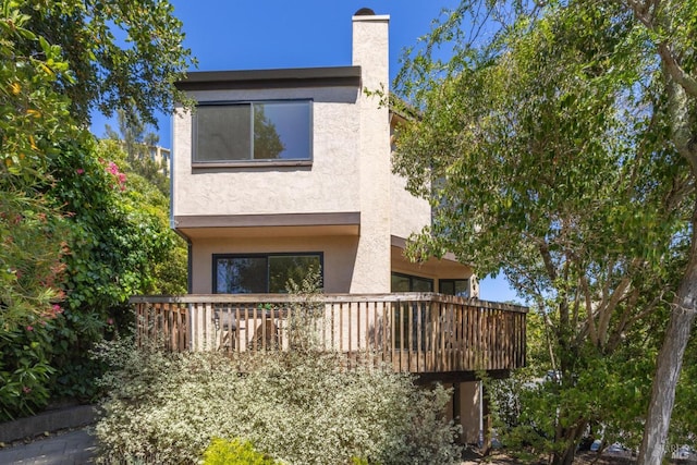 14 Corte Real Ct, Greenbrae, CA 94904 - back of house featuring stucco siding, a balcony, and a chimney