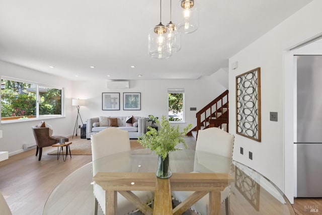 14 Corte Real Ct, Greenbrae, CA 94904 - dining space with healthy amount of natural light, light wood-style floors, stairs, a wall unit AC, and recessed lighting