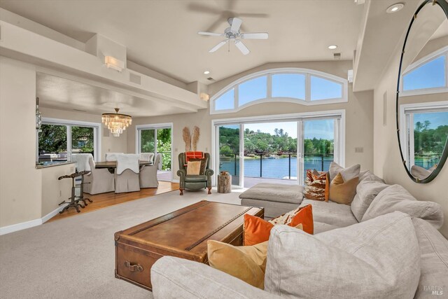 18903 N Shore Dr, Hidden Valley Lake, CA 95467 - living room featuring lofted ceiling, a water view, a chandelier, a ceiling fan, and carpet floors