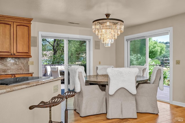 18903 N Shore Dr, Hidden Valley Lake, CA 95467 - dining room with healthy amount of natural light, light wood-style flooring, and a chandelier