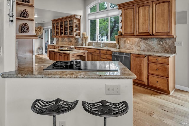 18903 N Shore Dr, Hidden Valley Lake, CA 95467 - kitchen with open shelves, black electric stovetop, dishwasher, light wood-style floors, and backsplash