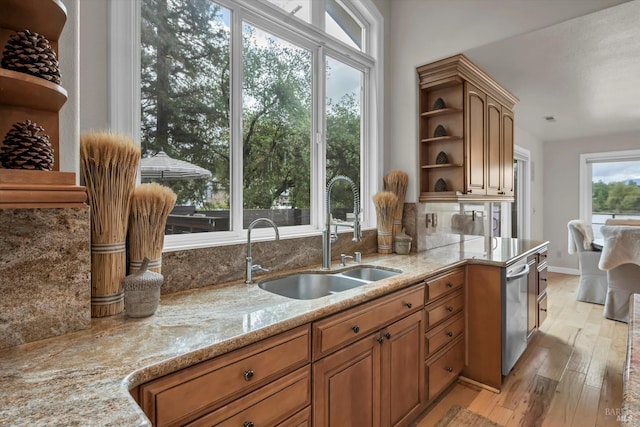 18903 N Shore Dr, Hidden Valley Lake, CA 95467 - kitchen with open shelves, light stone counters, light wood-style floors, and brown cabinetry