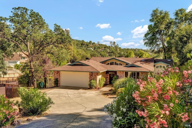 18903 N Shore Dr, Hidden Valley Lake, CA 95467 - view of front of property featuring a garage, concrete driveway, and brick siding