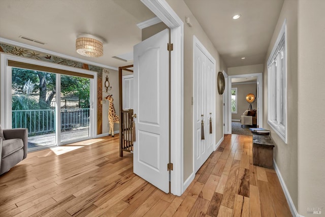 18903 N Shore Dr, Hidden Valley Lake, CA 95467 - hall featuring light wood-style flooring, plenty of natural light, and crown molding