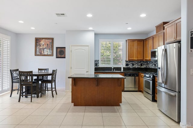 448 Potters Ln, Vacaville, CA 95687 - kitchen featuring appliances with stainless steel finishes, dark countertops, a center island, recessed lighting, and tasteful backsplash