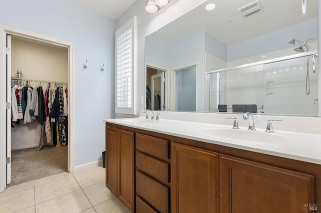 448 Potters Ln, Vacaville, CA 95687 - full bathroom with a stall shower, double vanity, a walk in closet, and tile patterned floors