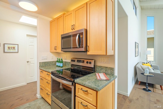 495 S Eliseo Dr Unit 7, Greenbrae, CA 94904 - kitchen featuring stainless steel appliances, light brown cabinetry, and light wood-style floors