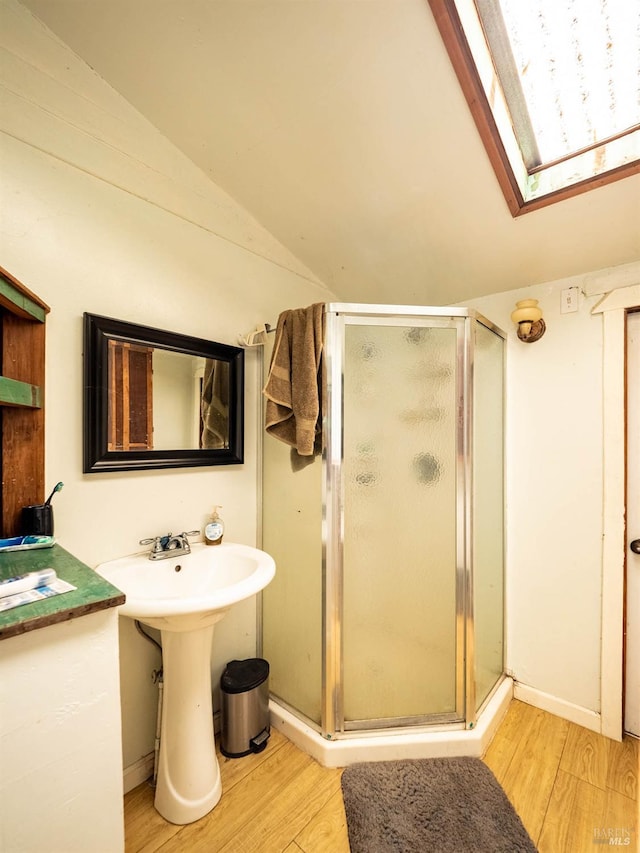 5820 Ruddock Rd N, Philo, CA 95466 - bathroom with lofted ceiling, wood finished floors, a stall shower, and a skylight
