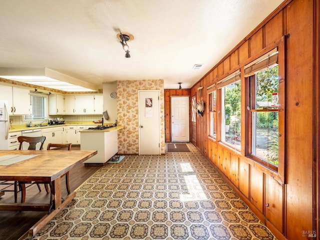 5820 Ruddock Rd N, Philo, CA 95466 - kitchen featuring light floors, light countertops, white appliances, and wood walls