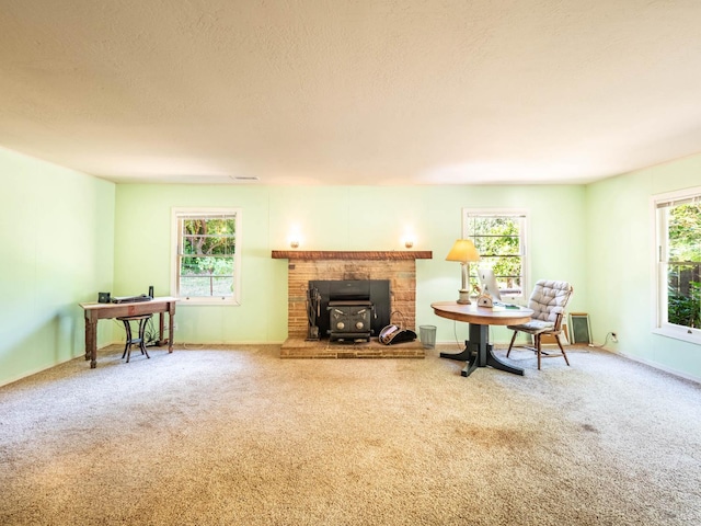 5820 Ruddock Rd N, Philo, CA 95466 - living area featuring a wood stove, carpet, and a textured ceiling