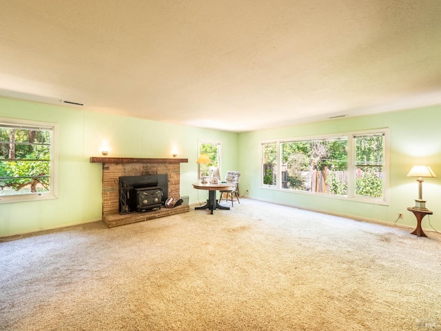 5820 Ruddock Rd N, Philo, CA 95466 - living room featuring a wood stove, carpet flooring, and healthy amount of natural light