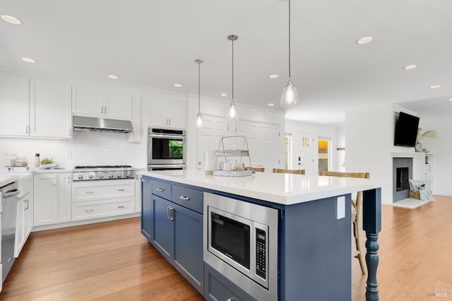 251 Donegal Way, Martinez, CA 94553 - kitchen featuring stainless steel appliances, blue cabinets, under cabinet range hood, white cabinetry, and recessed lighting