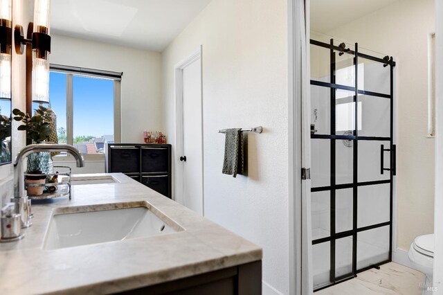 196 Caldwell Dr, Vacaville, CA 95687 - bathroom featuring double vanity, a walk in shower, and marble look tiles