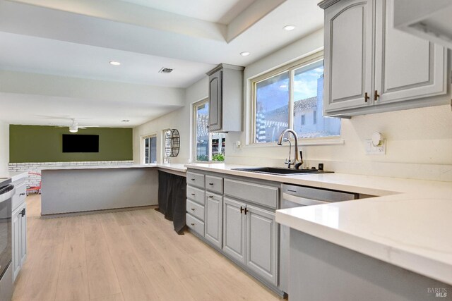 196 Caldwell Dr, Vacaville, CA 95687 - kitchen with gray cabinets, open floor plan, light countertops, recessed lighting, and light wood-style flooring