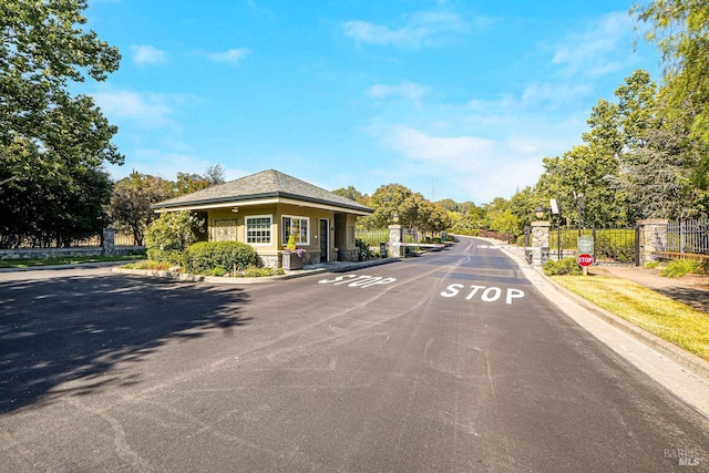 5313 Autumn Rock Ct, Fairfield, CA 94534 - view of asphalt road with curbs, a gated entry, and traffic signs
