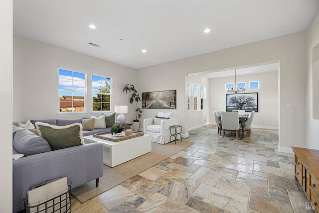 5313 Autumn Rock Ct, Fairfield, CA 94534 - living area with stone tile floors, recessed lighting, and a chandelier